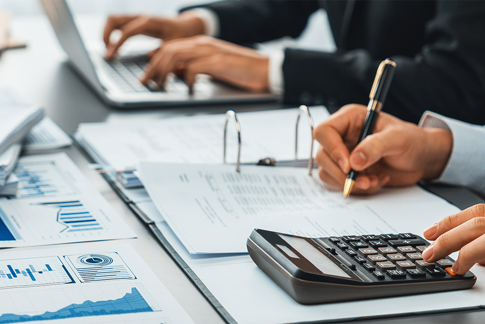 close up of someone budgeting with calculator